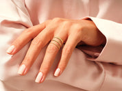 Gold stackable rings on hand, elegant jewelry for women