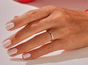 Elegant gold ring on a manicured hand, jewelry photography