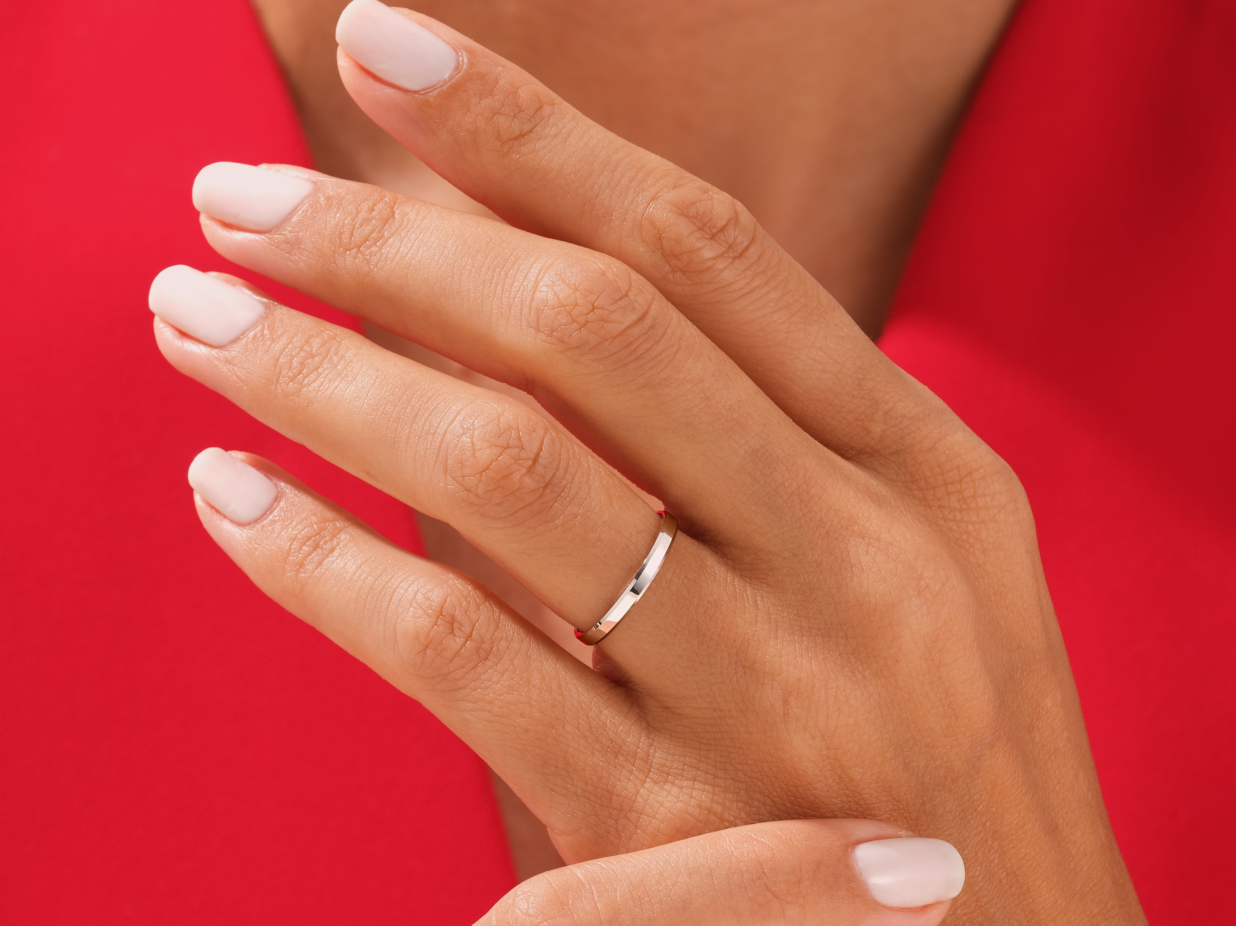 Elegant silver band ring on a hand, jewelry photography