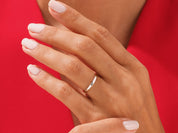 Elegant silver band ring on a hand, jewelry photography