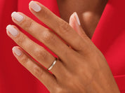 Minimalist gold band ring on a hand, jewelry photography