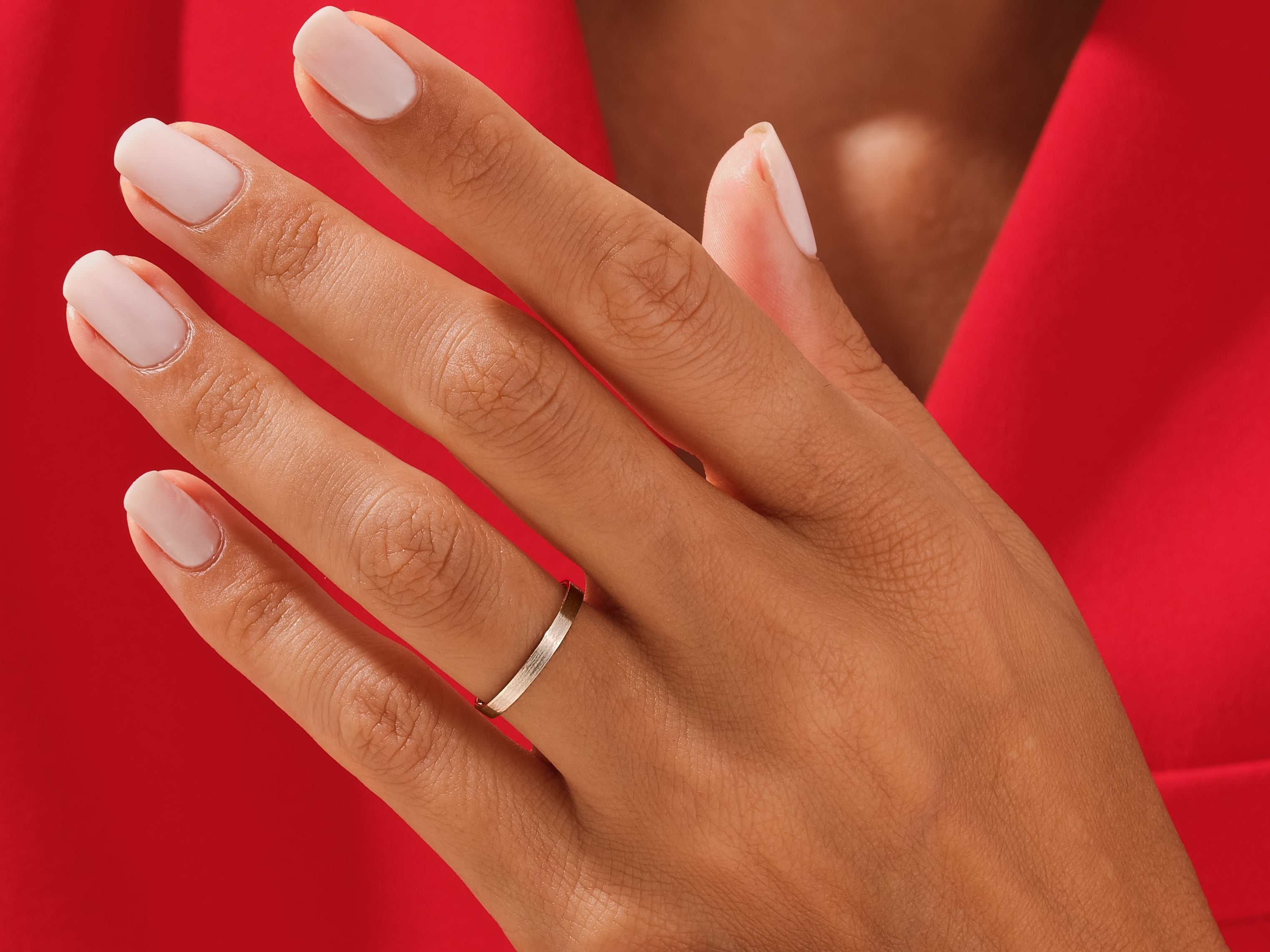 Minimalist gold band ring on a hand, jewelry photography