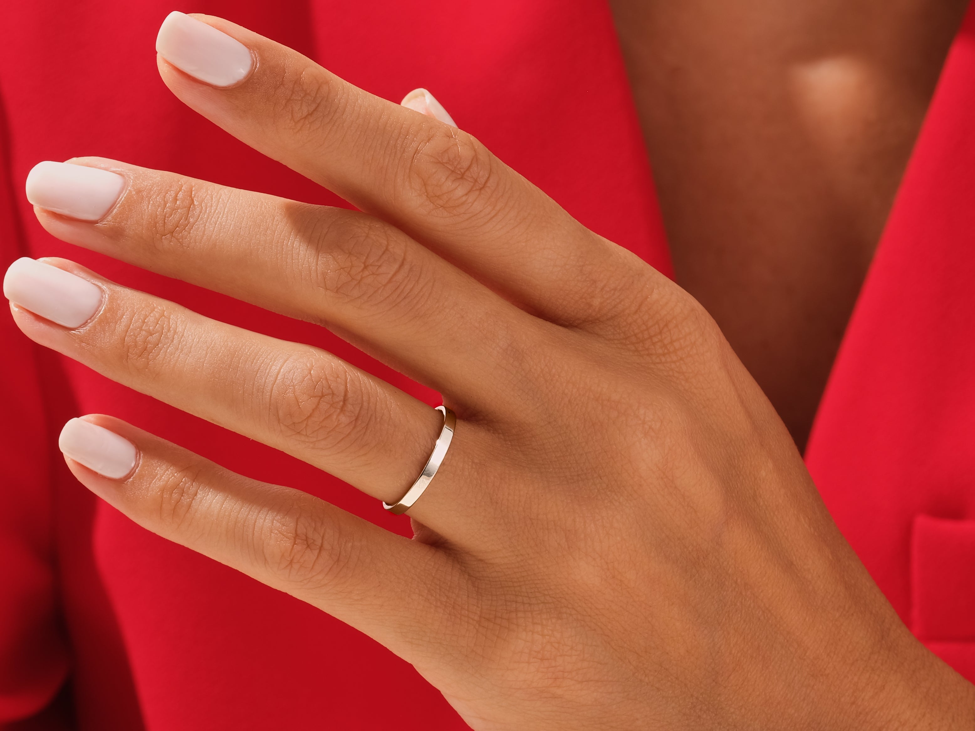 Minimalist silver band ring on a woman's hand
