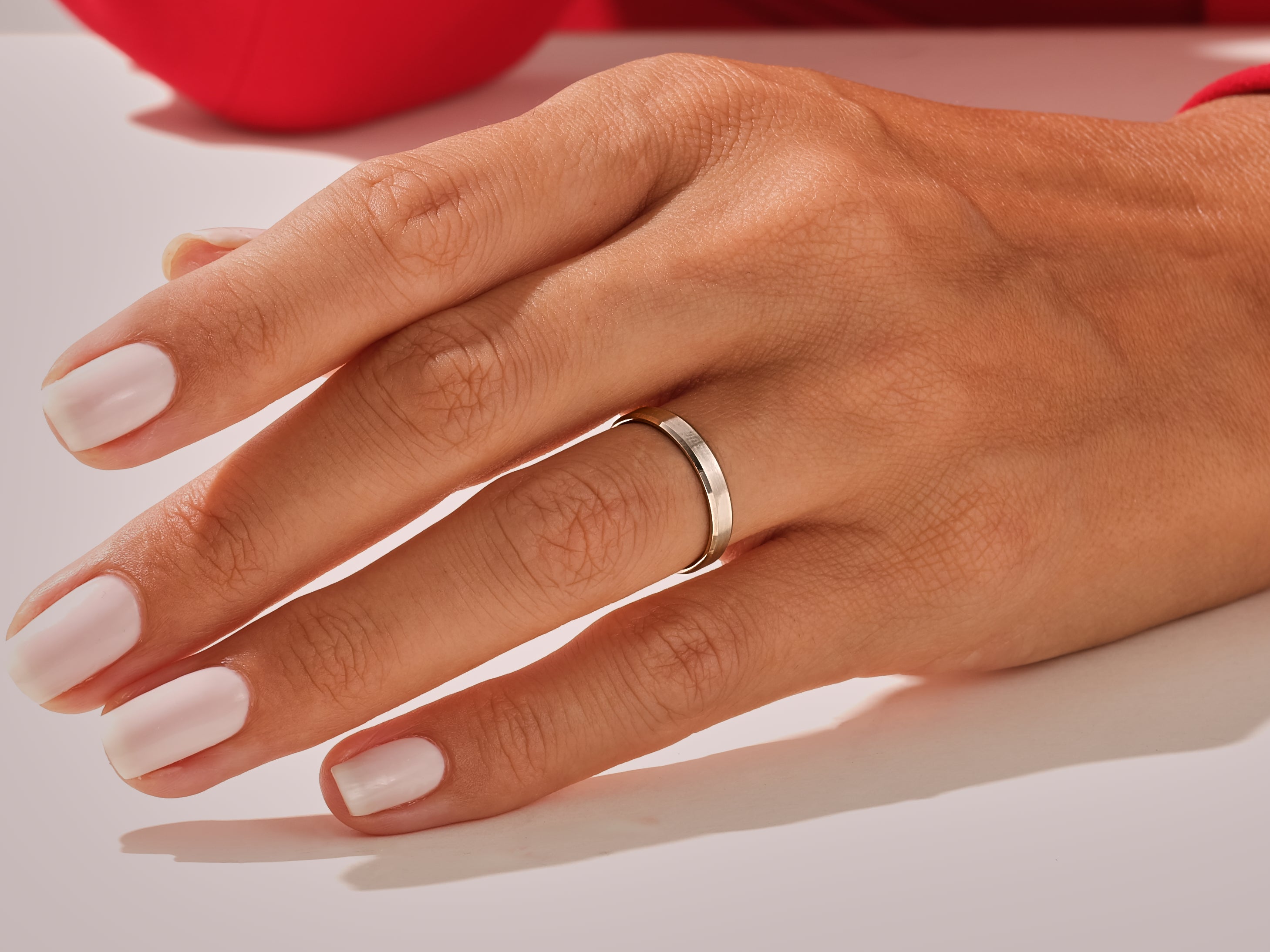 Elegant silver band ring on a manicured hand, jewelry photography