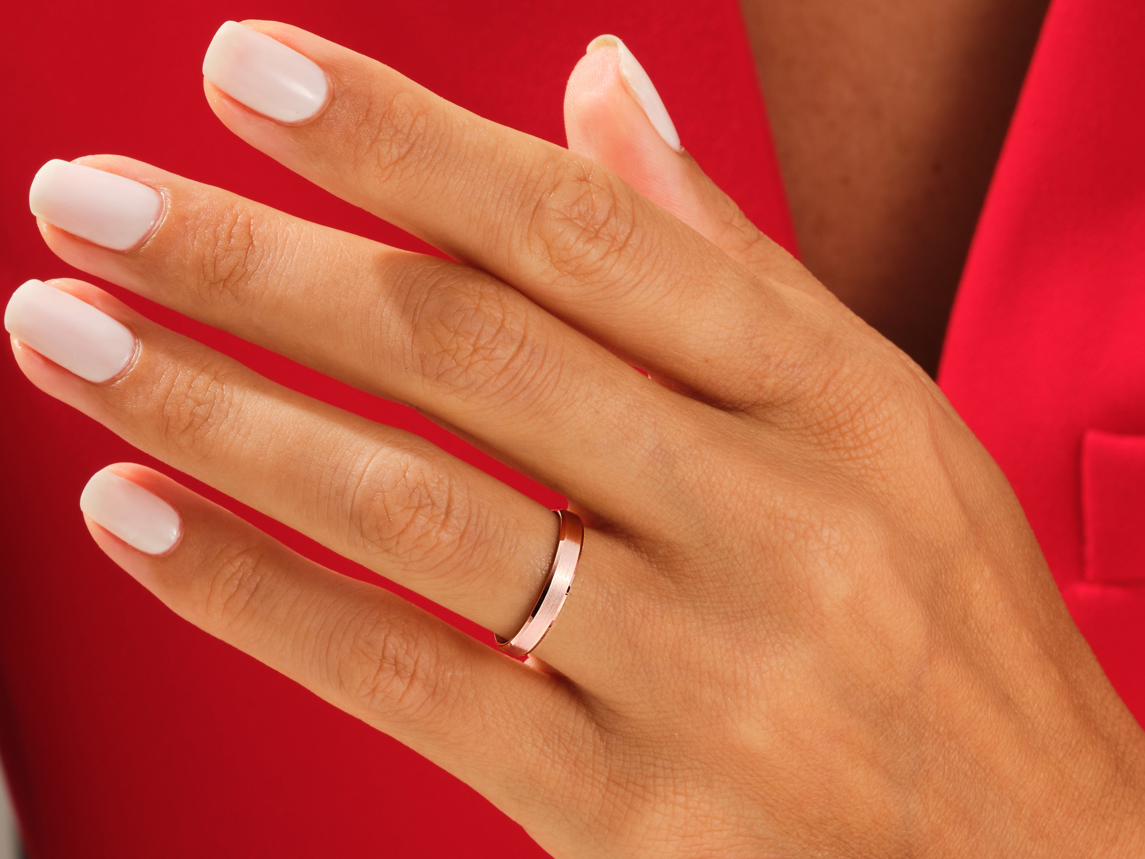 Rose gold band ring on a hand, jewelry product photography