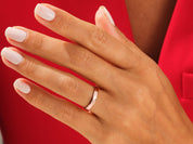 Rose gold band ring on a hand, jewelry product photography