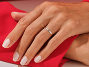 Elegant gold ring with inlaid design on a hand