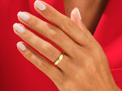 Gold wedding band on a hand, jewelry photography