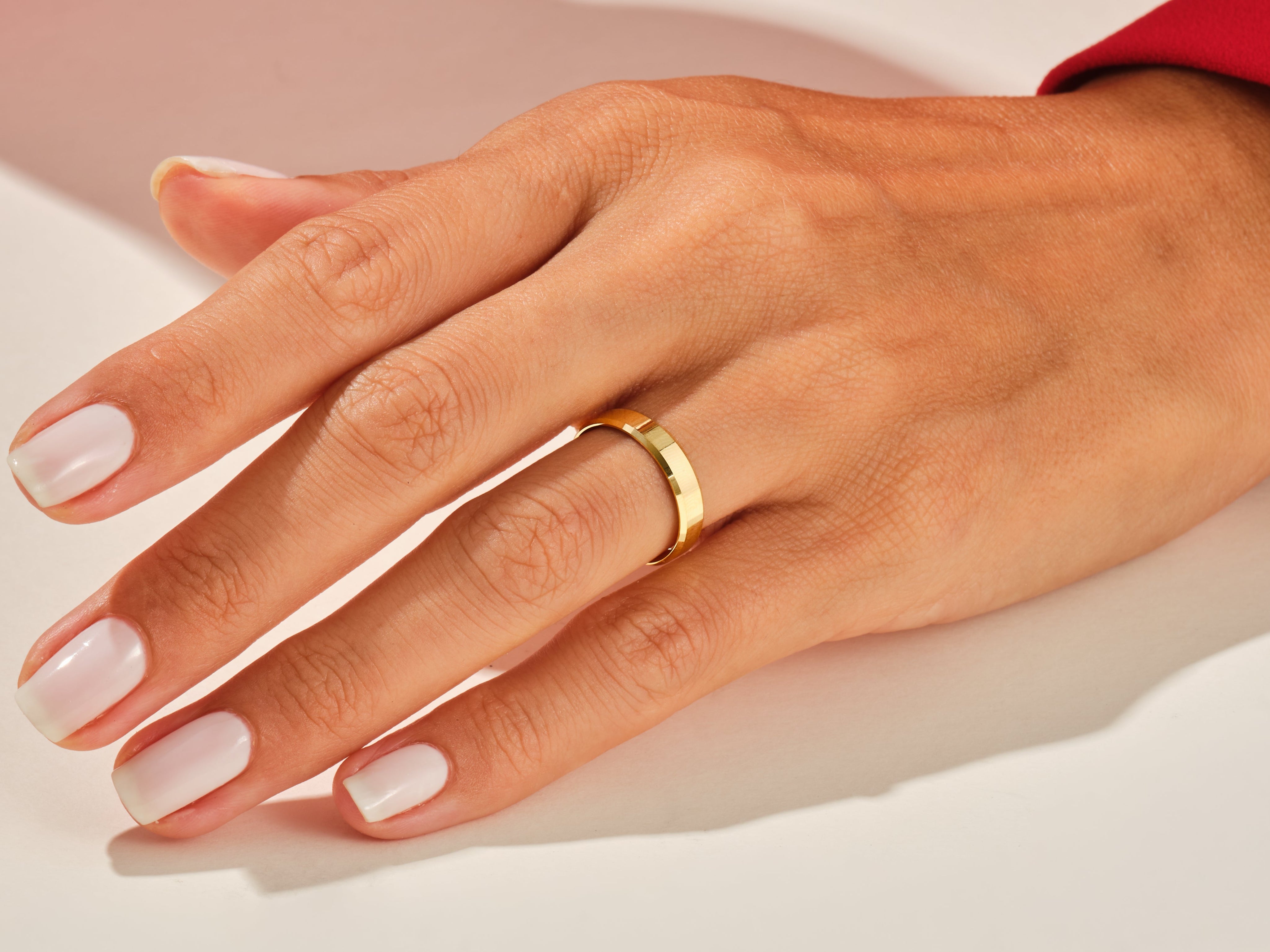 Gold band ring on a hand, jewelry product photography