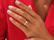 Elegant gold wedding band on a hand, jewelry firm product