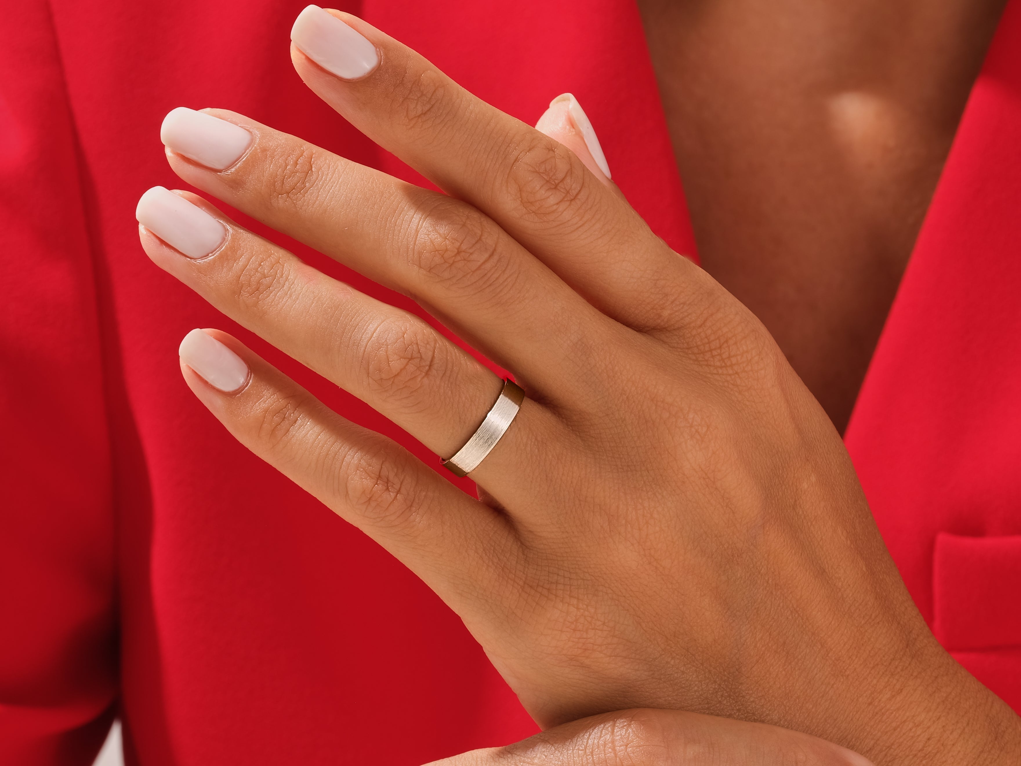 Elegant gold wedding band on a hand, jewelry firm product