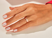 Rose gold brushed band ring on a woman's finger