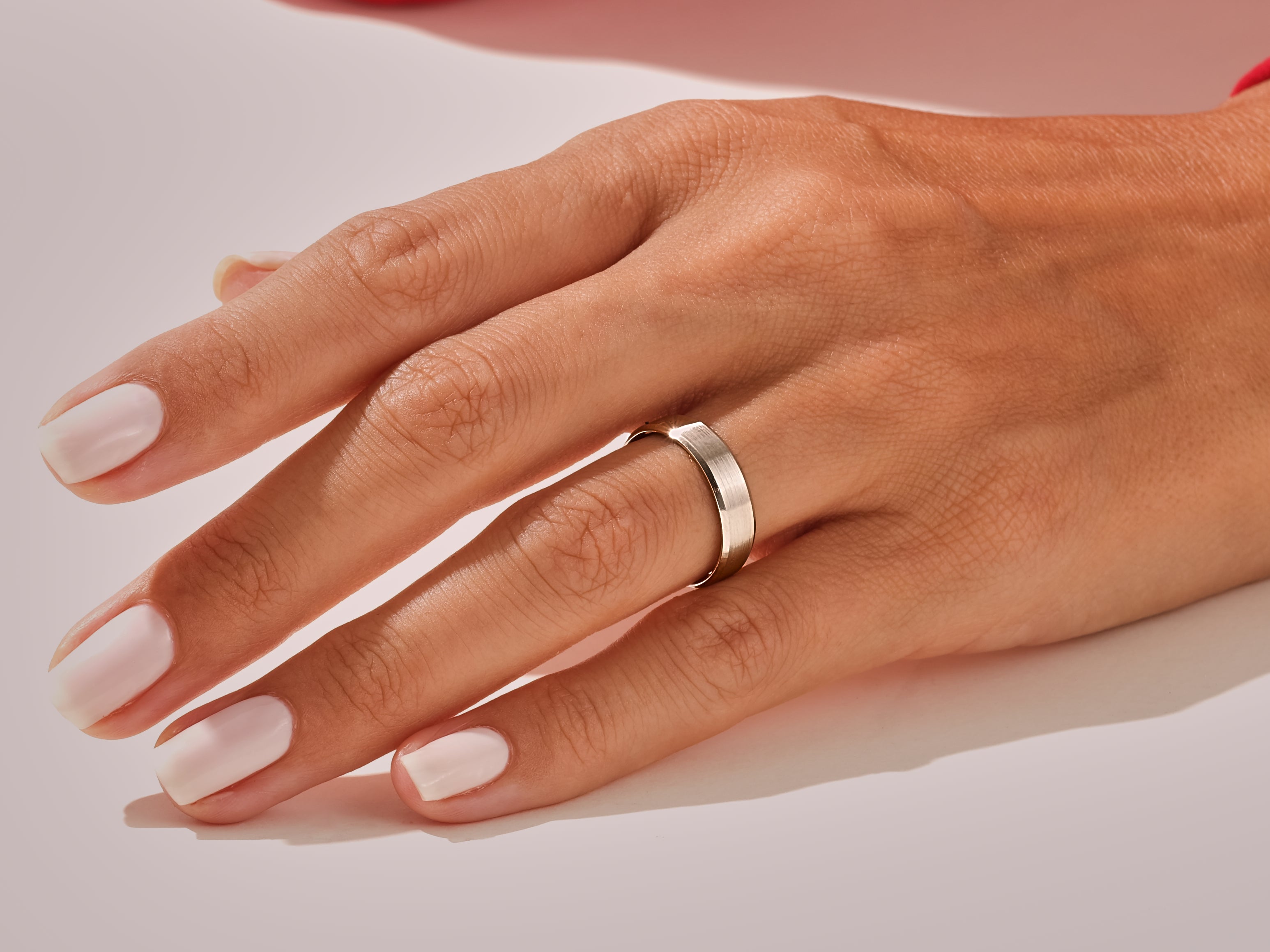 Elegant silver band ring on a woman's hand, jewelry photography