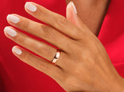 Rose gold ring on a hand with white nails, jewelry