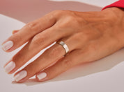 Jewelry: Simple brushed silver band ring on a manicured hand