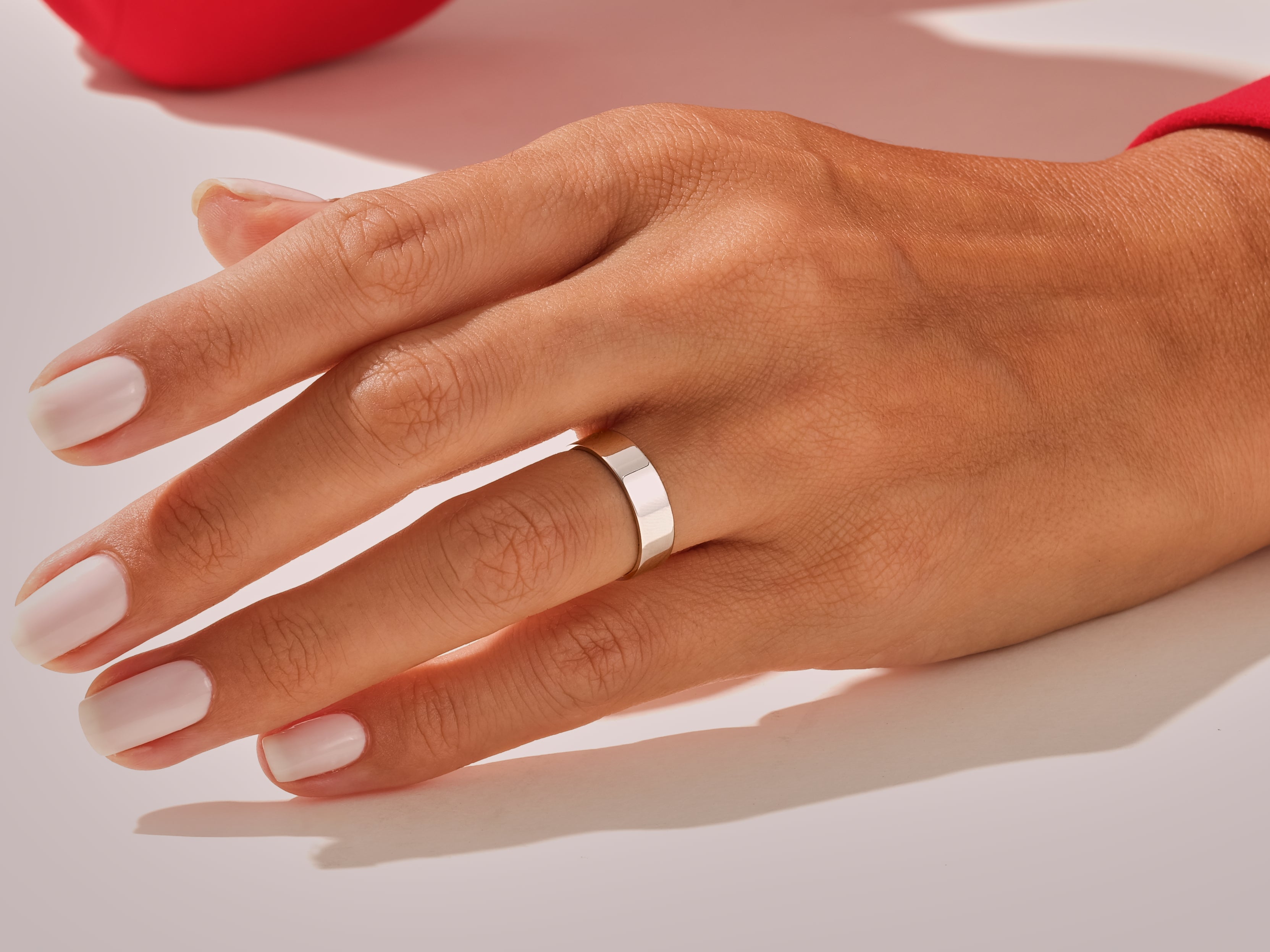 Elegant silver band ring on a hand, jewelry photography