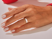 Elegant silver band ring on a hand, jewelry photography