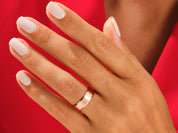 Rose gold ring on a hand, jewelry product photography