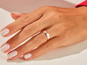 Rose gold band ring on a woman's hand, jewelry photography