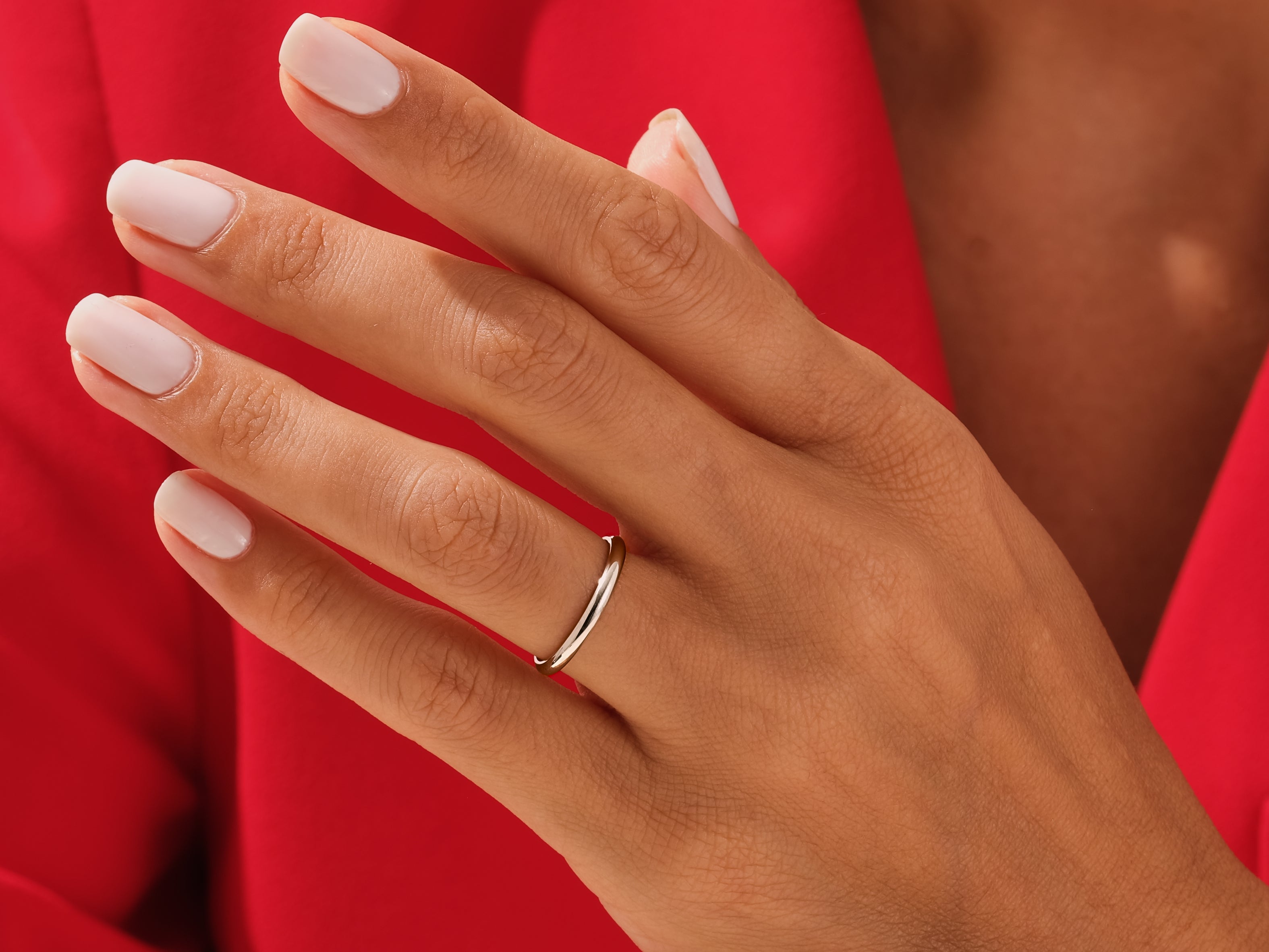 Elegant silver band ring on a hand with manicured nails