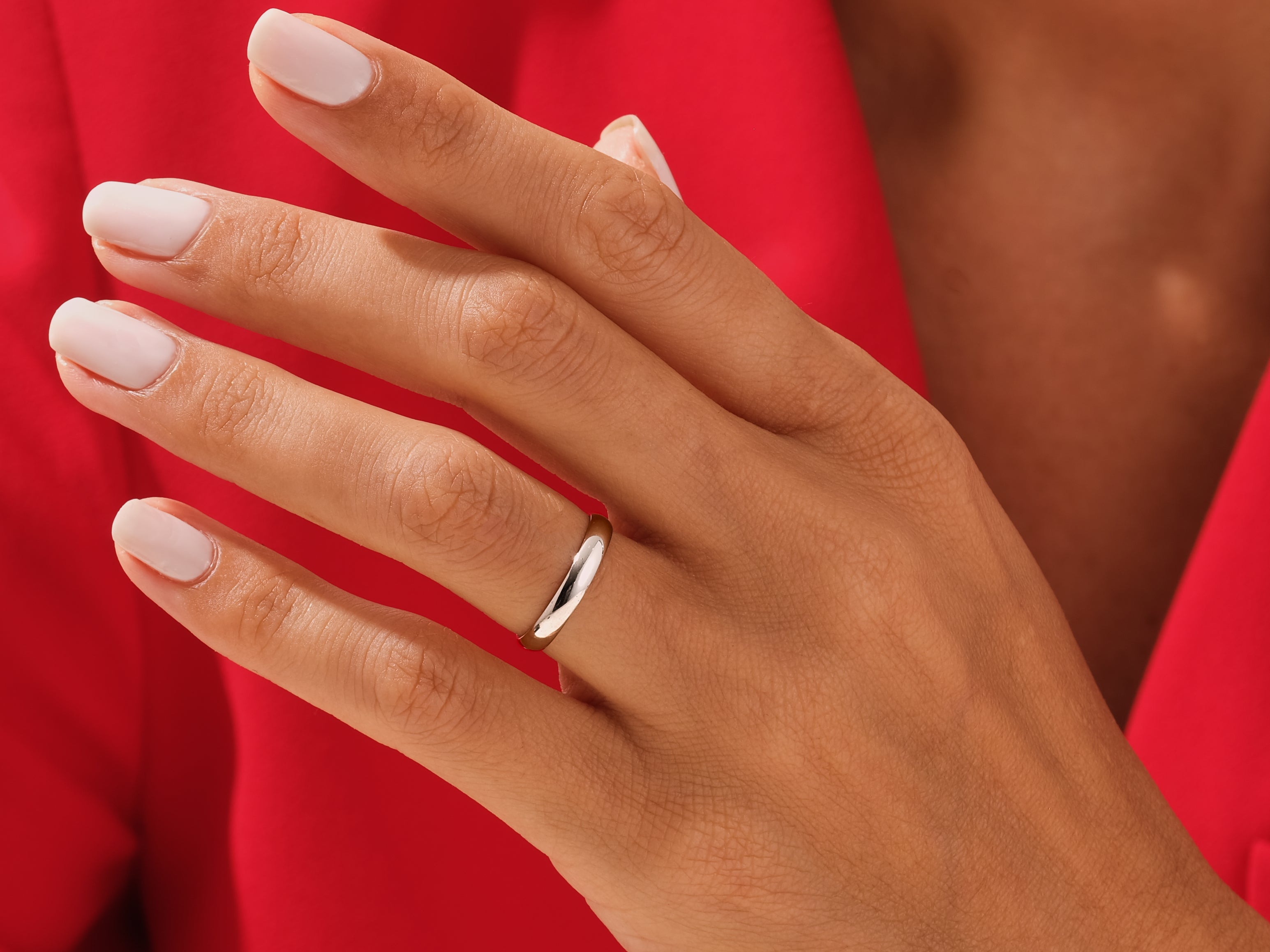 Elegant silver band ring on a hand, jewelry product photography