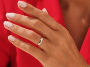 Elegant silver band ring on a hand, jewelry product photography