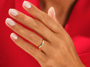 Gold wedding band on a hand with white nails, jewelry