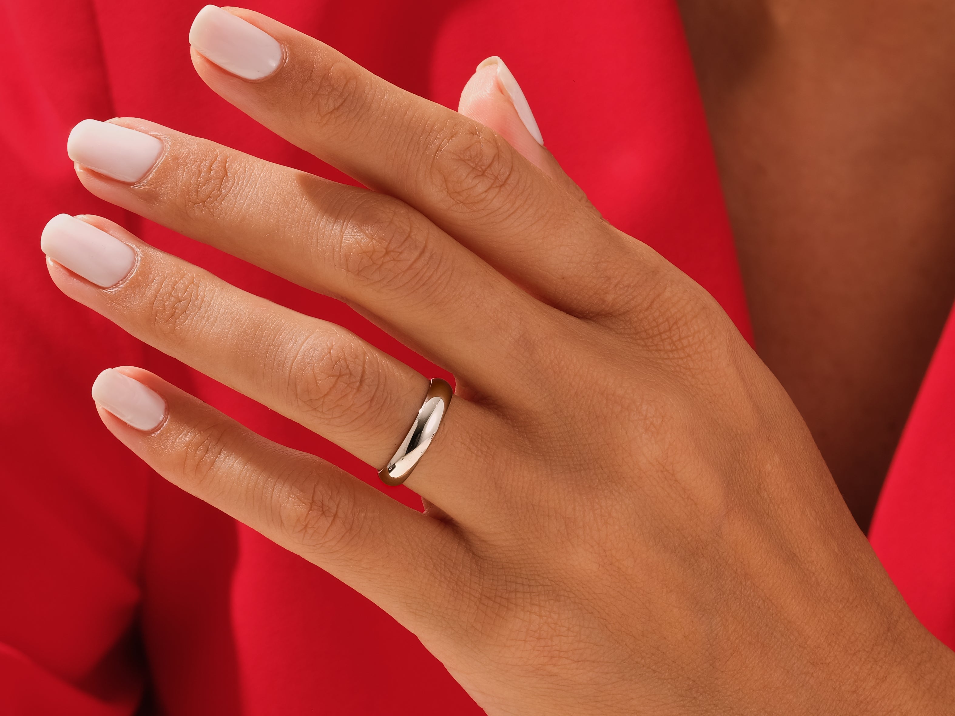 Elegant gold ring on a woman's hand, showcasing fine jewelry craftsmanship