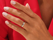 Elegant gold ring on a woman's hand, showcasing fine jewelry craftsmanship