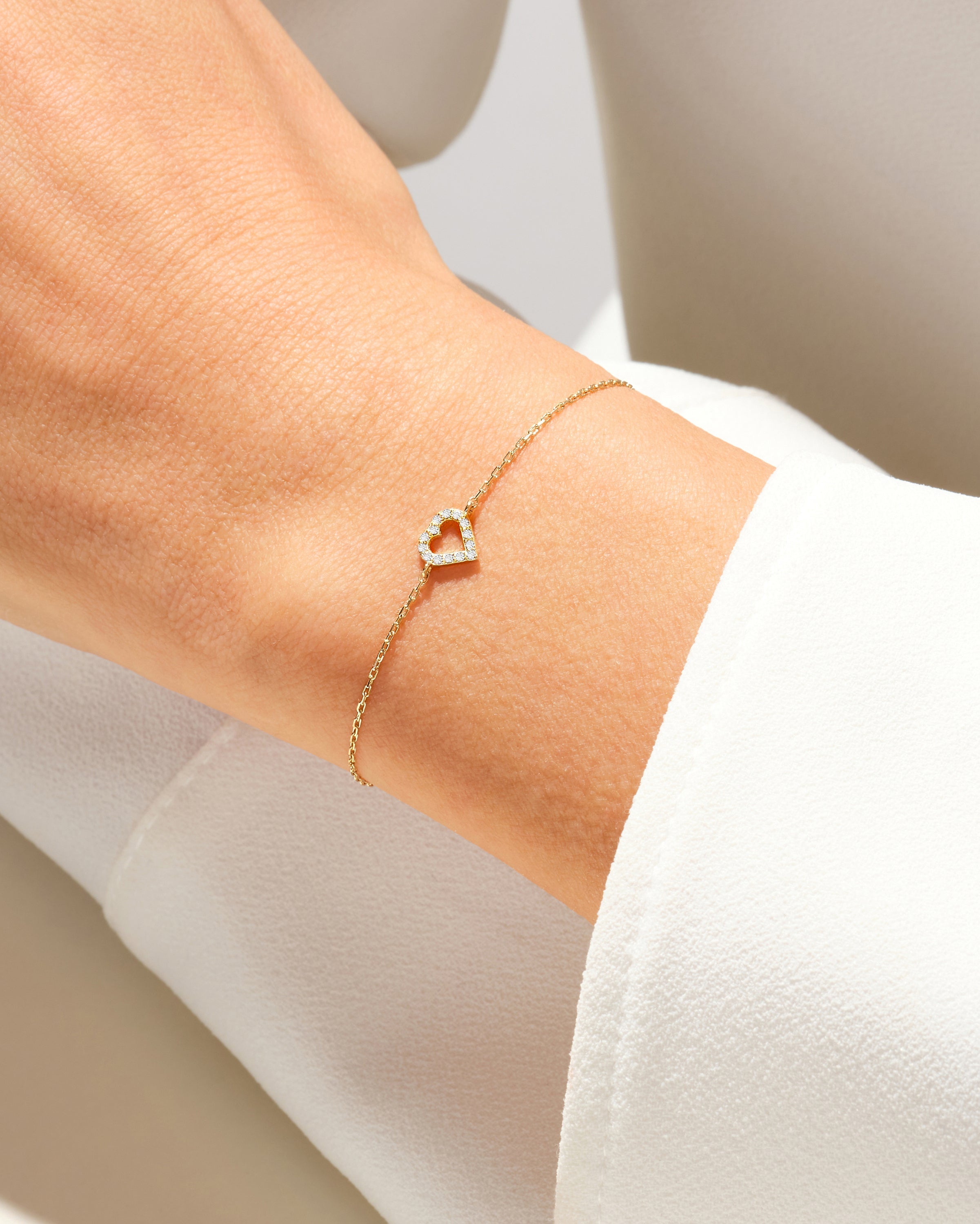 Diamond heart bracelet on a woman's wrist, fine jewelry