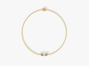 Gold chain bracelet with a single baguette diamond centerpiece
