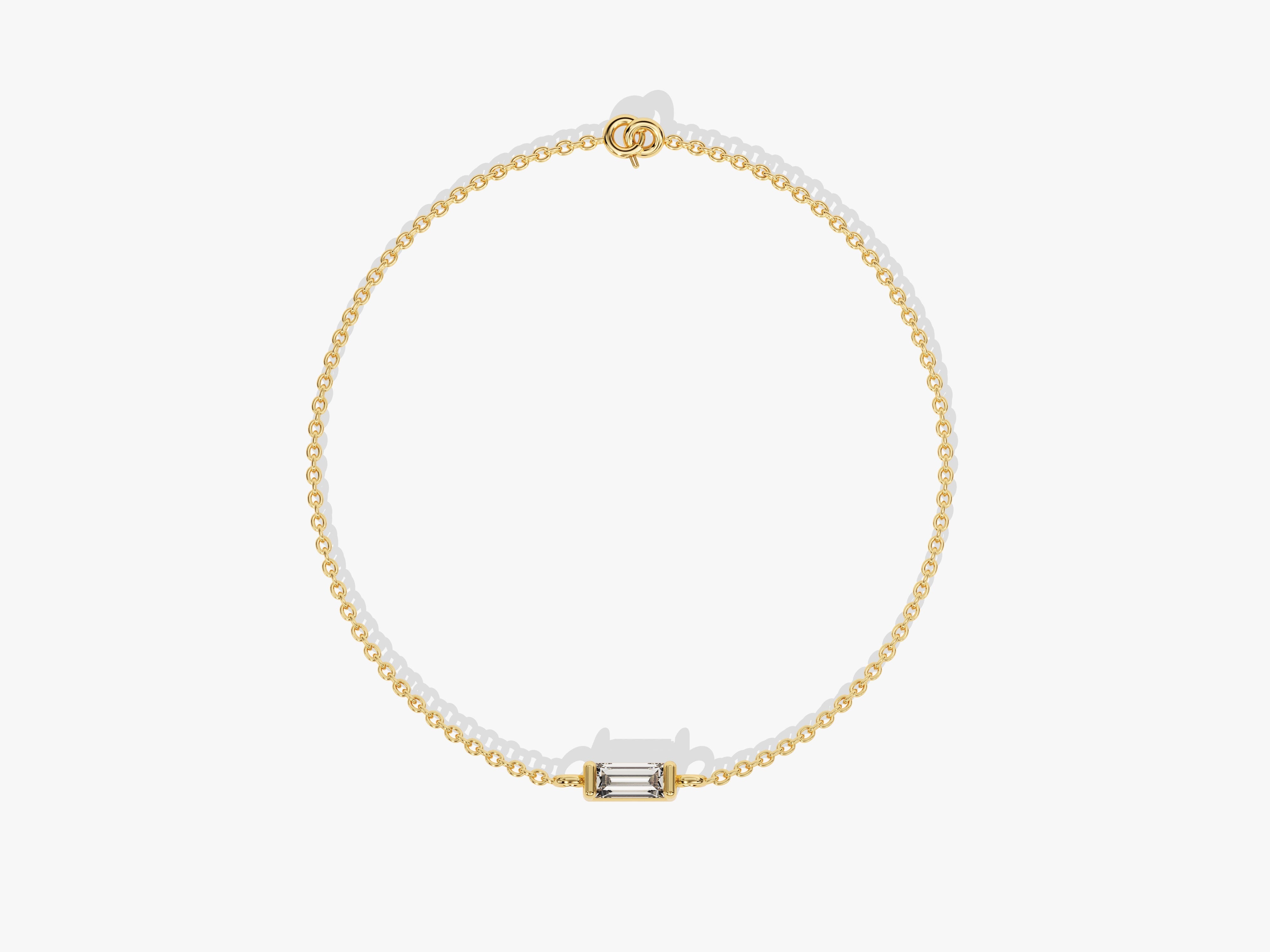 Gold chain bracelet with a single baguette diamond centerpiece