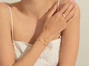 Gold bracelet and ring on a woman's arm