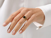 Gold signet ring with black onyx gemstone on a woman's hand