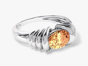 Silver ring with oval orange gemstone, jewelry design