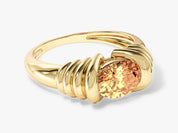 Gold ring with oval cut orange gemstone, jewelry design