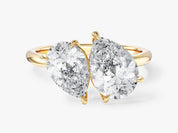 Two pear-shaped diamonds on a gold ring