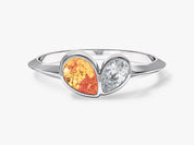 Silver ring with orange gemstone and diamond heart design