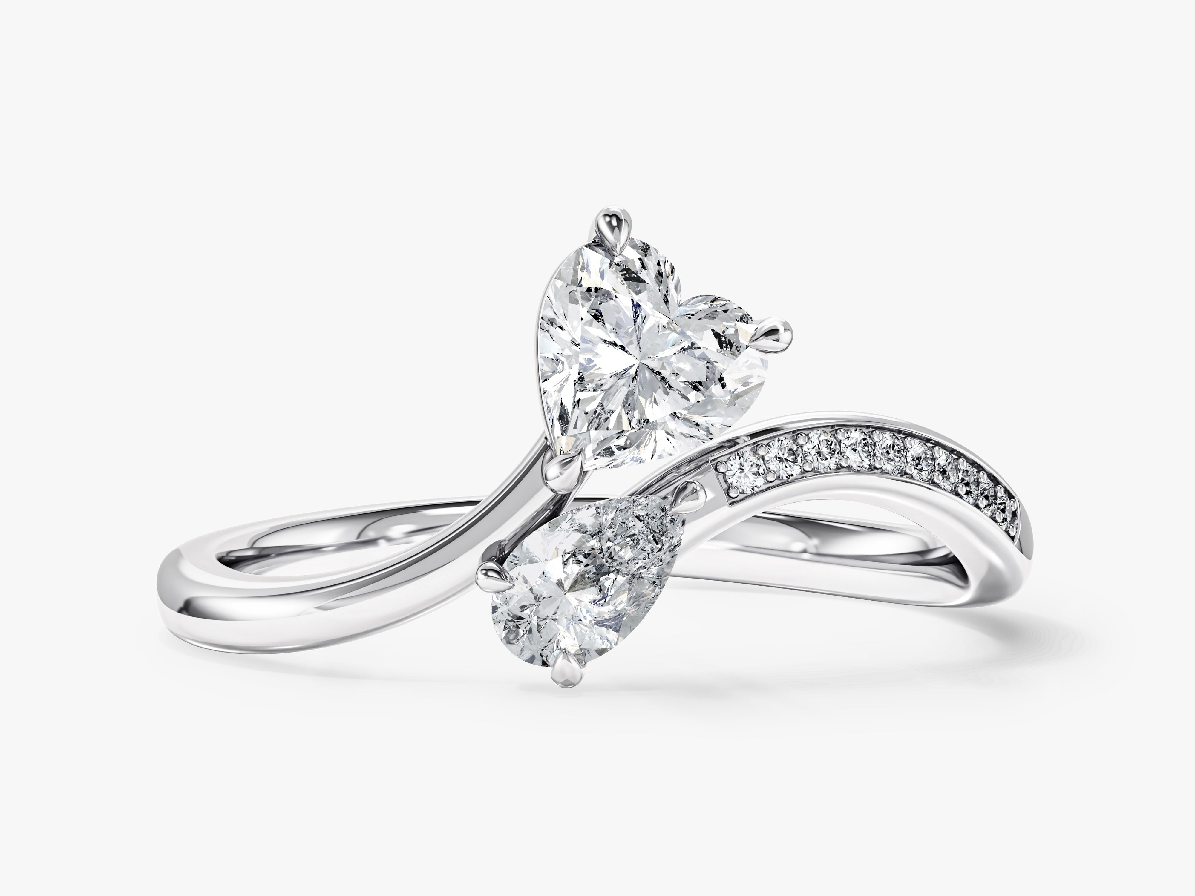 Diamond engagement ring with heart and pear shape stones