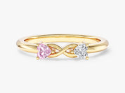 Gold ring with intertwined infinity band and heart-shaped pink and white diamonds