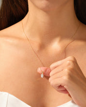 Elegant gold necklace with diamond pendant on a woman's neck