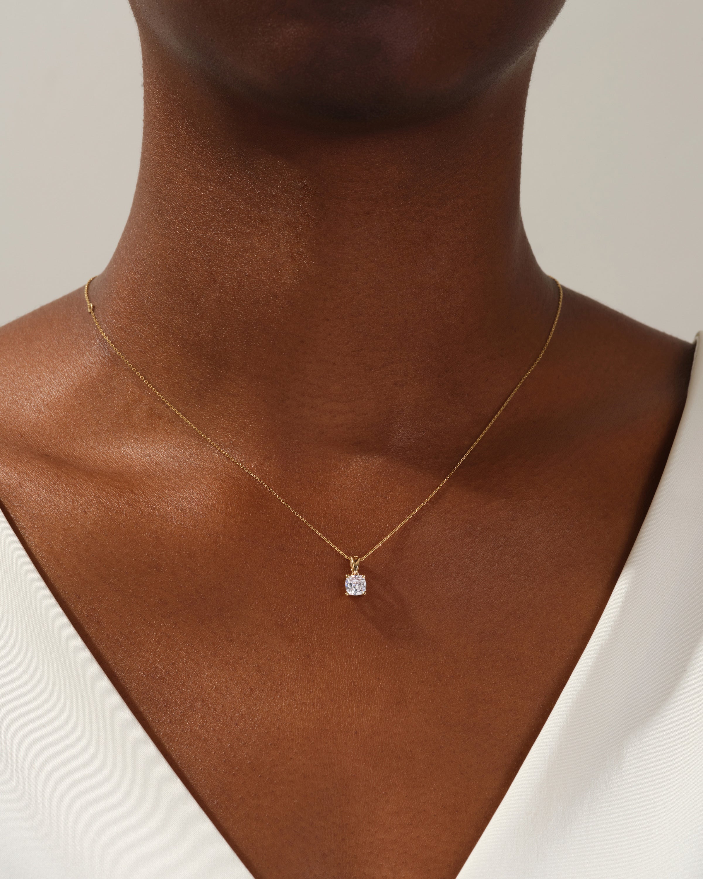 Diamond solitaire necklace on a woman's neck, fine jewelry