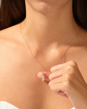 Gold necklace with diamond pendant on a woman's neck