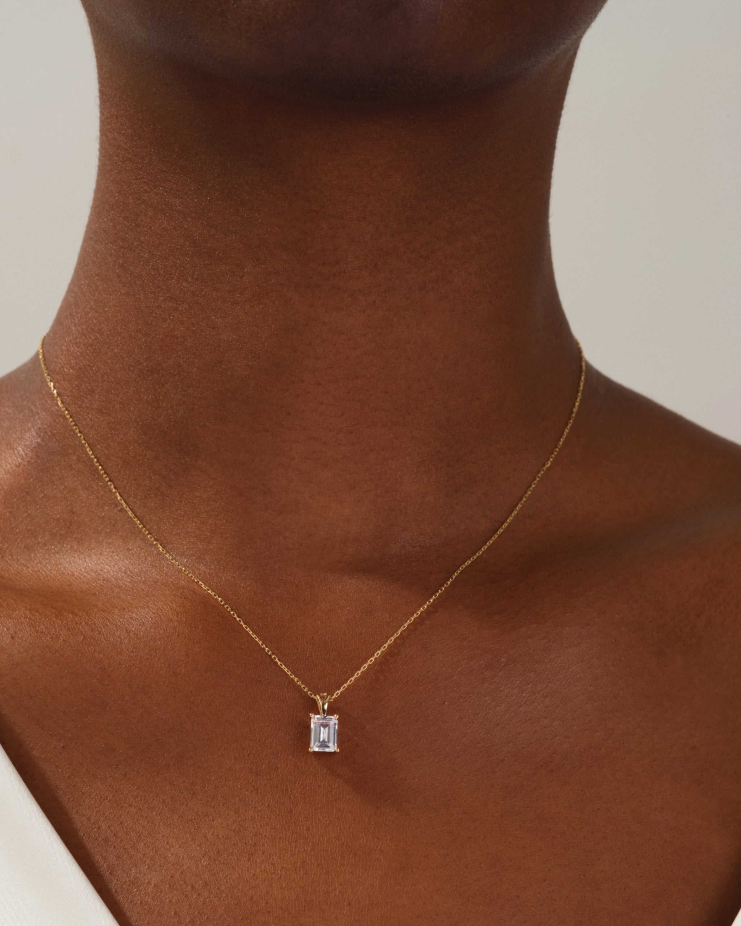 Emerald cut diamond pendant necklace on gold chain