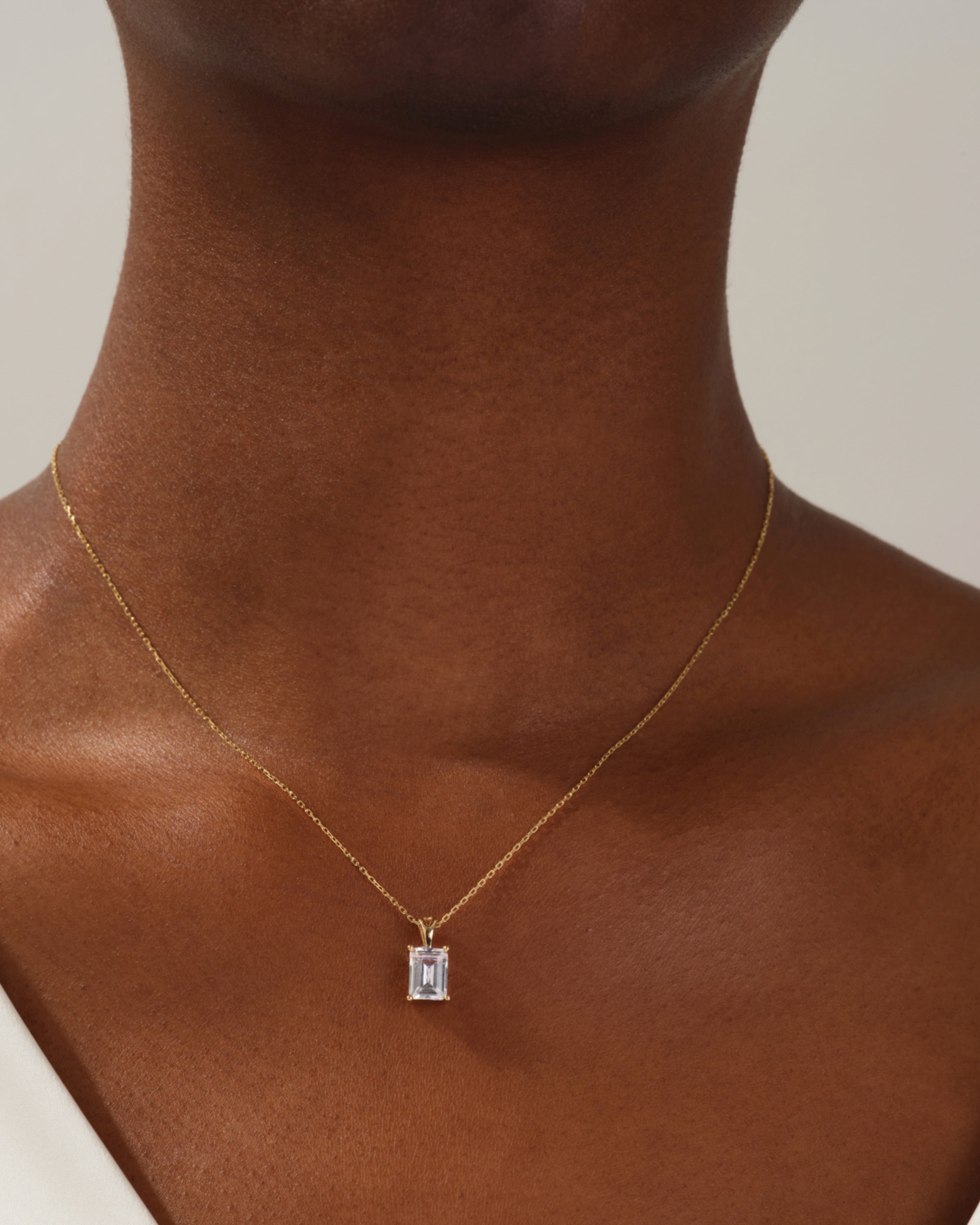 Emerald cut diamond pendant necklace on gold chain