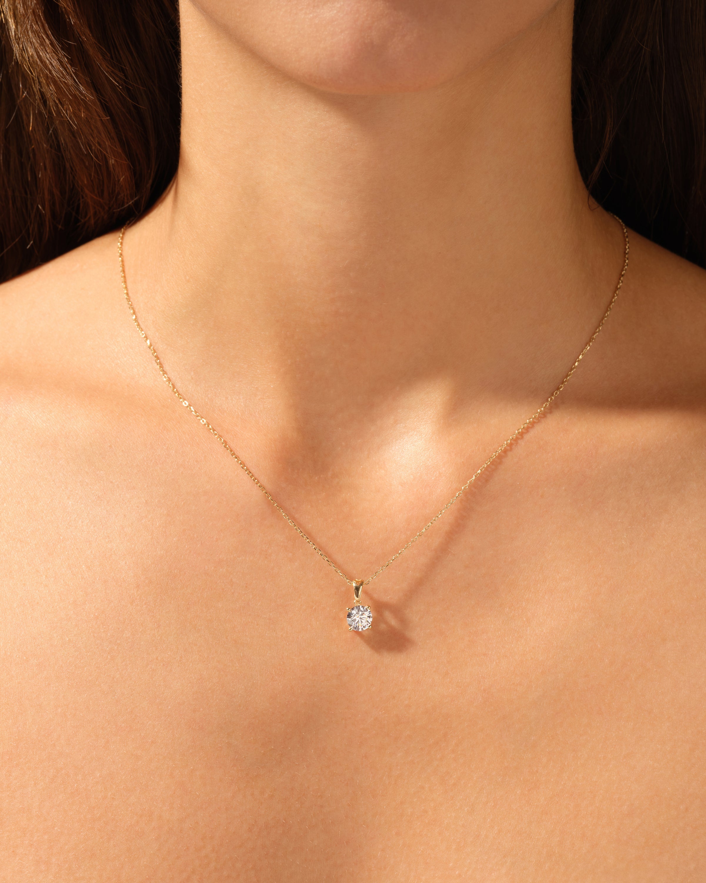 Diamond pendant necklace on a woman's neck, fine jewelry