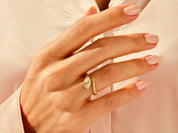 Gold snake ring on a woman's hand, elegant jewelry