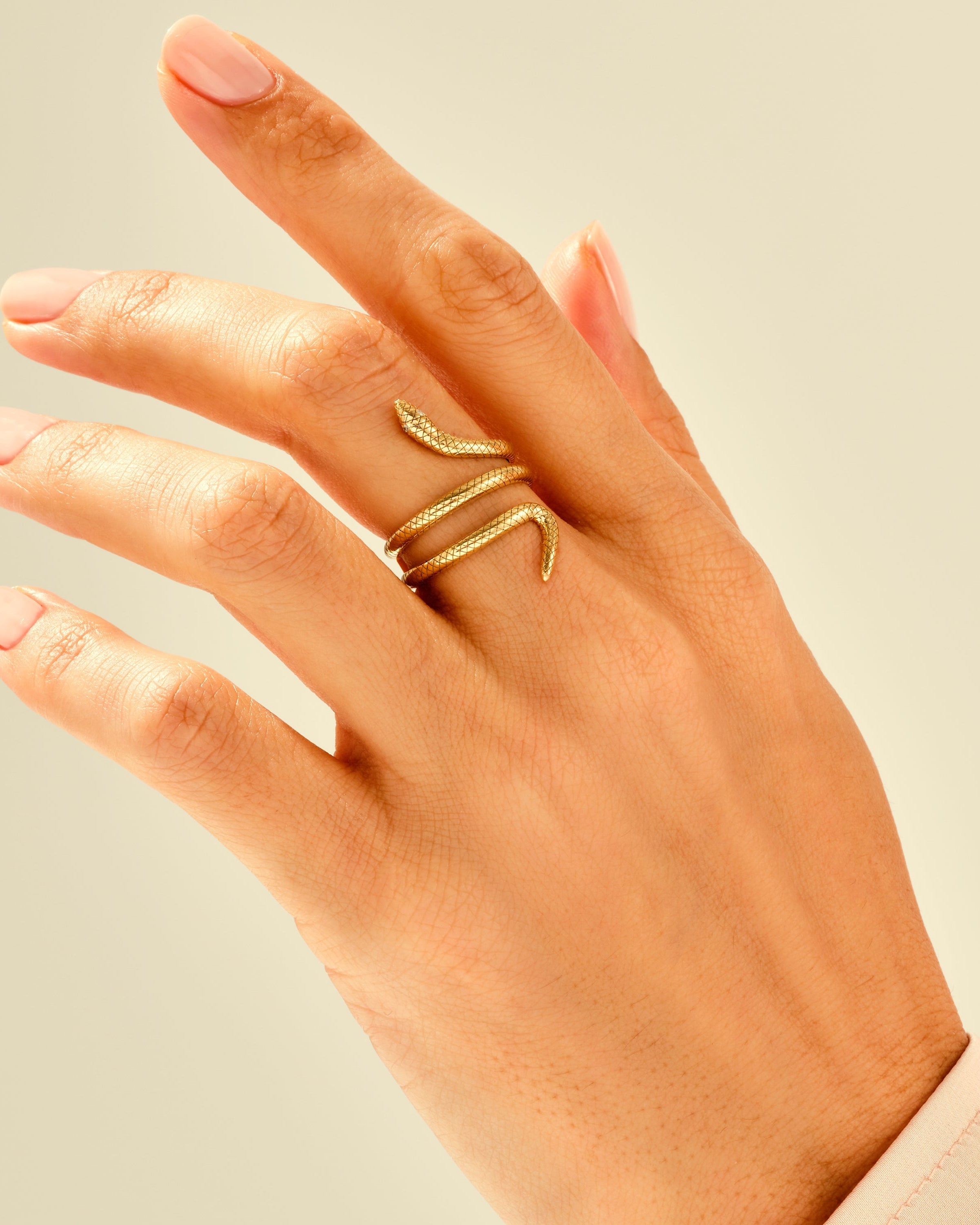 Gold snake ring on a hand, fine jewelry for women