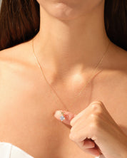 Gold necklace with diamond pendant on a woman's neck