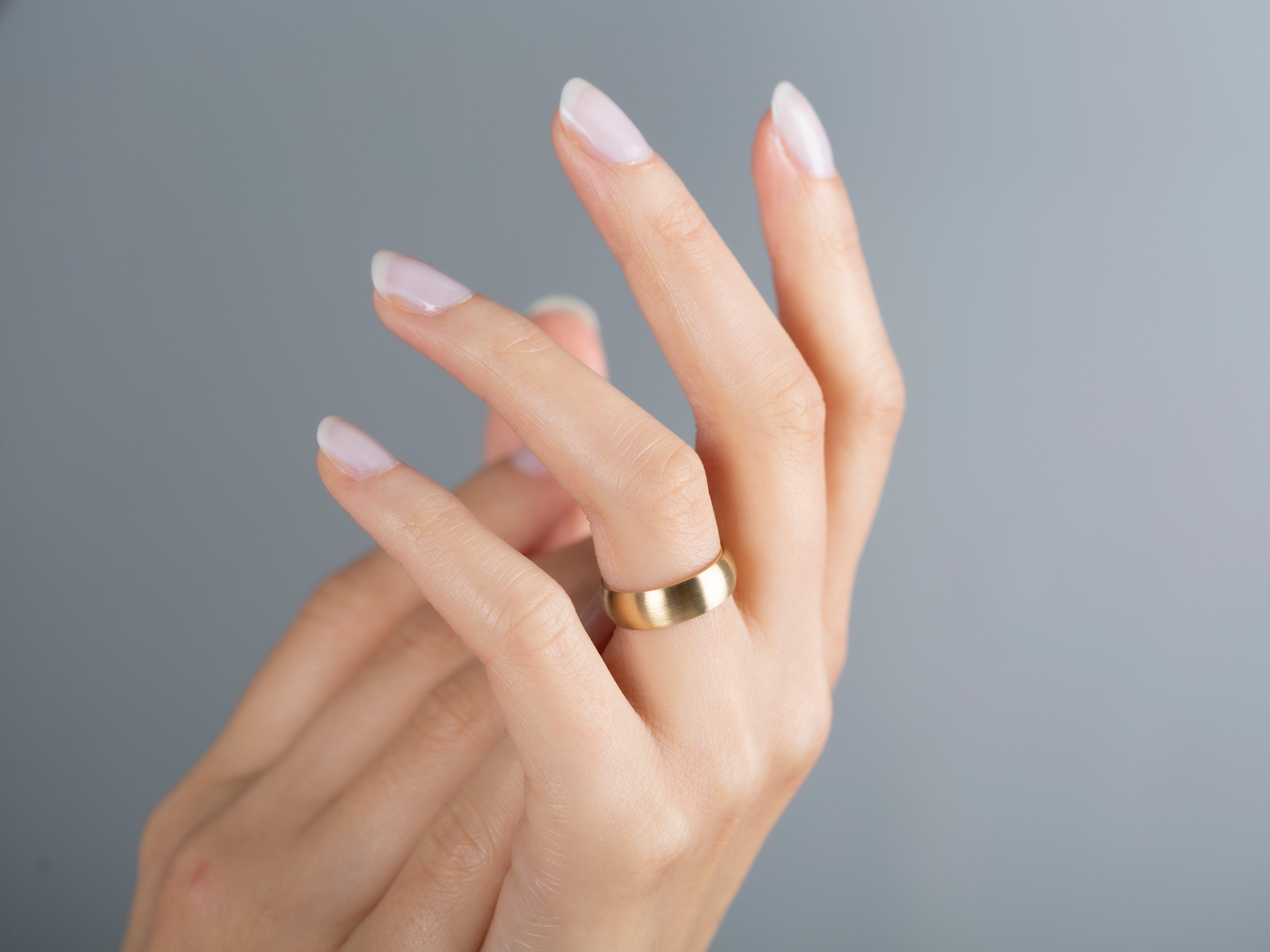 Elegant gold ring on a woman's hand, jewelry photography